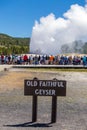 Tourists watching the Old Faithful erupting in Yellowstone National Park Royalty Free Stock Photo