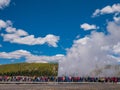 Tourists watching Old Faithful geyser erupting in Yellowstone Royalty Free Stock Photo
