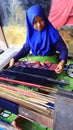 Tourists while watching the process of making woven cloth typical of the Sasak tribe of Lombok