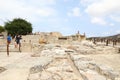 Tourists by ruins of palace Knossos archeological site on Crete
