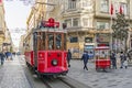 Touristy red nostalgic tram on istiklal street between modern and historical buildings