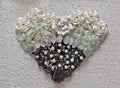 Tourmaline, quart and aquamarine crystals heart shape closeup on elegant white