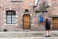 Tournai Doornik, Walloon Region - Belgium - Local tourist in summer dress looking at the facade and entrance of the Folklore