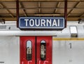 Tournai Doornik, Walloon Region- Belgium - Sign of the Tournai railwaystation with a local train waiting