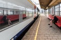 Tournai Doornik, Walloon Region - Belgium - Woman waiting for the train at the platform