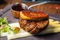 Tournedos Rossini. Foie gras, Black Angus beef tenderloin, white asparagus, red wine sauce. Delicious healthy Royalty Free Stock Photo