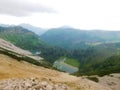 Top of mountain in austrian alpes with view in the small lake