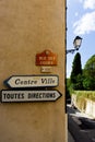 Toutes Directions and Centre Ville signs in the South of France village of Grimaud, Var, France