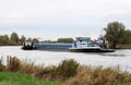 Tow boats drag rudderless freighter at dutch river