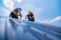 Tow construction worker safety wear using electric drill tools install on new roof metal sheet, Roof construction concept Royalty Free Stock Photo