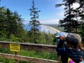 A woman admiring the views overlooking the beautiful ocean and forests of North Beach, in Naikoon Provincial Park, Haida Gwaii