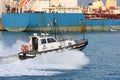 Tow pilot transits in the calm channel of the port of Genoa Royalty Free Stock Photo