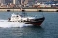 Tow pilot transits in the calm channel of the port of Genoa Royalty Free Stock Photo