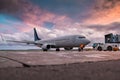 Tow tractor pushes passenger aircraft from boarding bridge Royalty Free Stock Photo