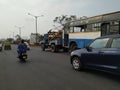 Tow truck delivers the damaged BMTC Bus, Repair and recovery vehicle towing a broken city bus Royalty Free Stock Photo