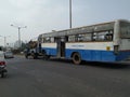 Tow truck delivers the damaged BMTC Bus, Repair and recovery vehicle towing a broken city bus Royalty Free Stock Photo