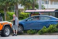 Tow truck driver pulling a vehicle from a accident stuck on a median