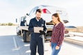 Tow truck operator and female driver checking the invoice Royalty Free Stock Photo
