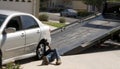 Tow-truck picking up broken down car Royalty Free Stock Photo