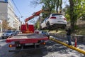 Tow truck takes away a wrongly parked car on central street in Kyiv, Ukraine. Violation of the traffic rules. Evacuating a car