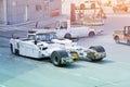 Tow truck vehicles with the mechanism for lifting the nose landing gear of the aircraft trailer for puch back plane at the Royalty Free Stock Photo