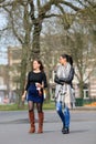 Tow youn cheerful woman having a walk in a park, Breda, Netherlands