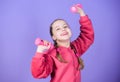 Toward healthier body. Rehabilitation concept. Girl exercising with dumbbell. Child hold little dumbbell violet Royalty Free Stock Photo