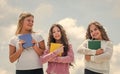 Towards knowledge. School students learning literature. kids reading books. three girls writing in notebook. back to