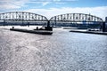 Towboat pushes dry bulk cargo barge under bridge on Mississippi River Royalty Free Stock Photo