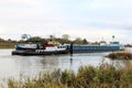 Towboats drag rudderless freighter at dutch river