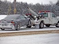wrecker towing a car in winter Royalty Free Stock Photo