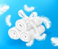 Towel background. Realistic folded cotton terry cloth. Heap of 3D soft textile napkins and falling white feathers. Fabric rolls Royalty Free Stock Photo