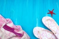 Towel and beach slippers on wood ,summer background. Top view and copy space Royalty Free Stock Photo