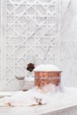 Towel and copper bowl with soap foam in turkish hamam. Tradition