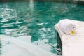 Towel and flower in luxury spa jacuzzi pool