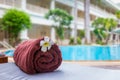 Towel with a flower near swimming pool.