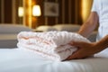 Towel placement Hotel maids hands close up, ensuring neat bed display