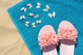 Towel, seashells and flip flops on sand, top view. Beach accessories Royalty Free Stock Photo