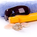 Towel, shells, sunglasses and lotion Royalty Free Stock Photo