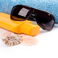 Towel, shells, sunglasses and lotion Royalty Free Stock Photo