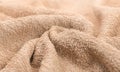 Towel texture closeup. Soft beige color cotton towel backdrop, fabric background. Terry cloth bath or beach towels Royalty Free Stock Photo