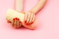 Towel of two colors pink and yellow in beautiful young woman`s hands. Royalty Free Stock Photo