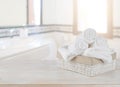 Towels in basket on wooden table over defocused bathroom background