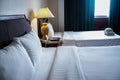 Towels and bedding on double beds in dormitories or guesthouse rooms that are empty Royalty Free Stock Photo