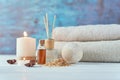 Towels, candle and massage oil on white table Royalty Free Stock Photo