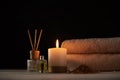 Towels, candle and massage oil on white table Royalty Free Stock Photo