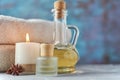 Towels, candle and massage oil on white table Royalty Free Stock Photo