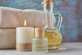 Towels, candle and massage oil on white table Royalty Free Stock Photo