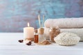 Towels, candle and massage oil on white table Royalty Free Stock Photo