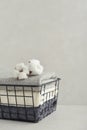 Towels with cotton flowers in black metal basket